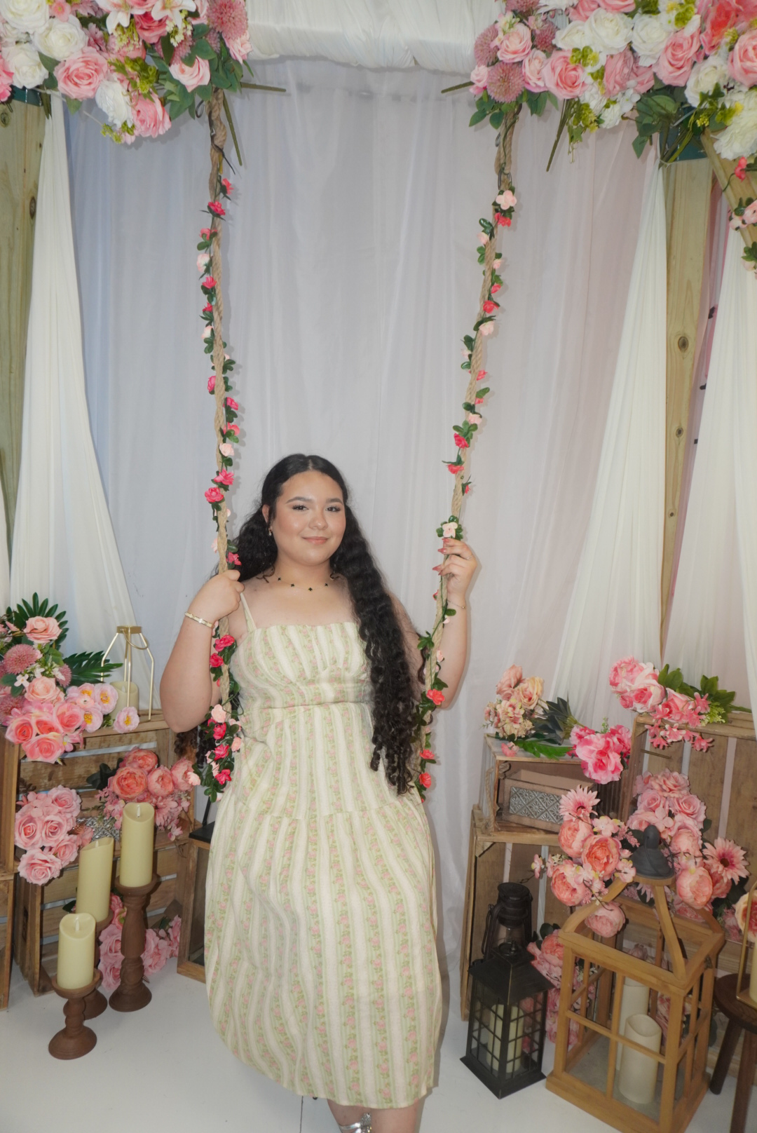 Katherine standing on a floral swing