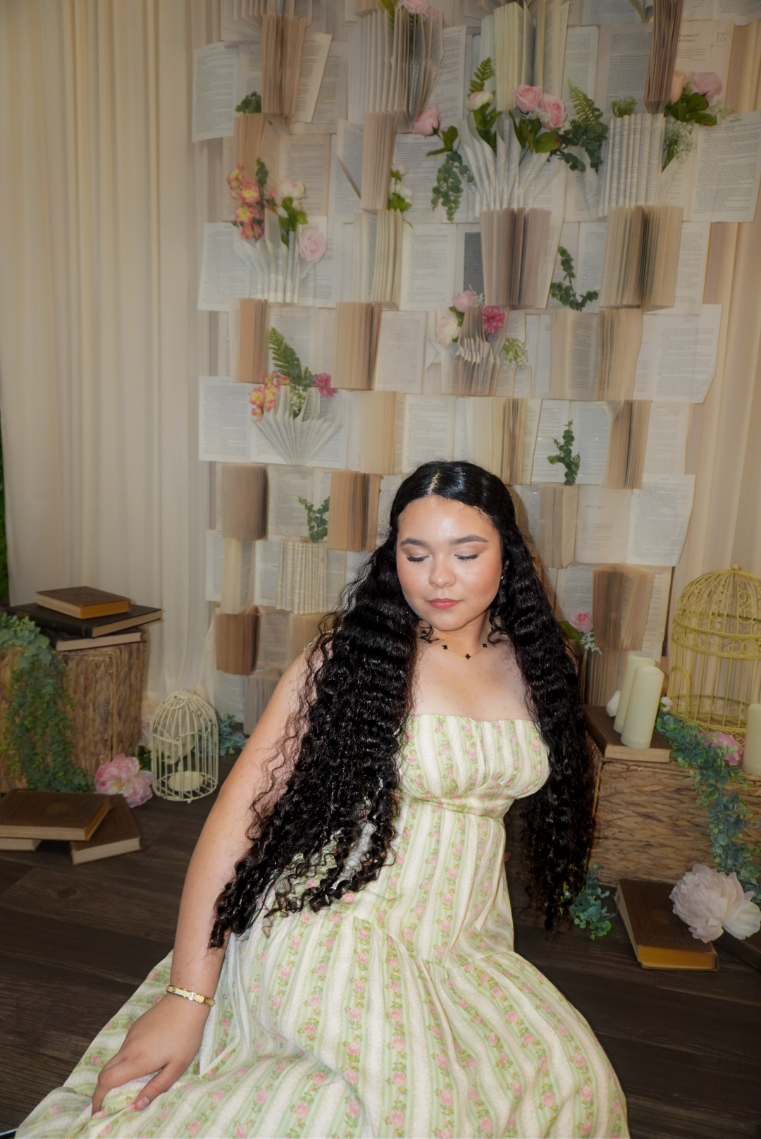 Katherine seated near a book display