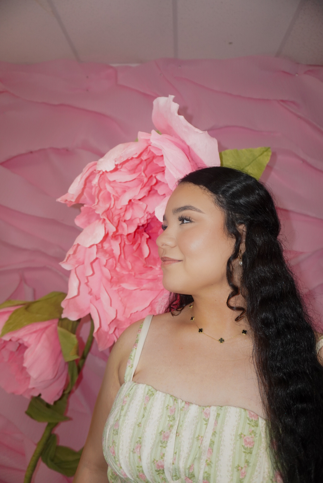 Katherine posing in front of pink flowers